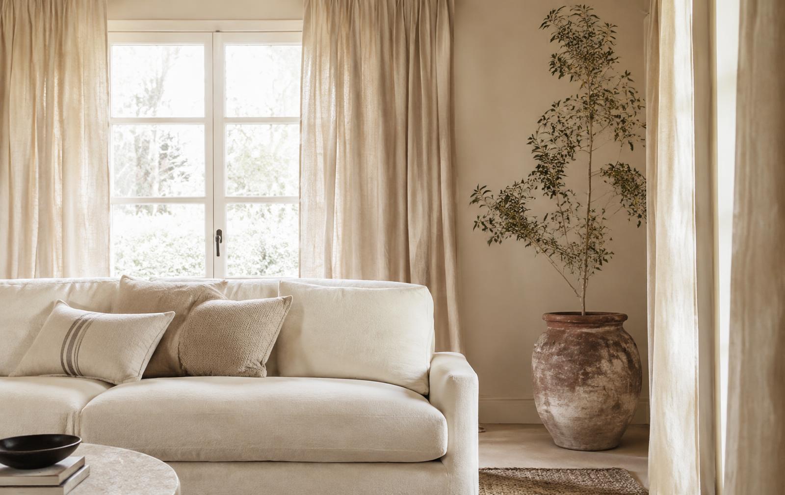 Living room with linen curtains and cushions
